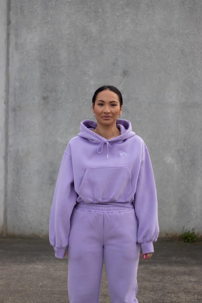 woman wearing loungewear joggers and hoodie in lavender