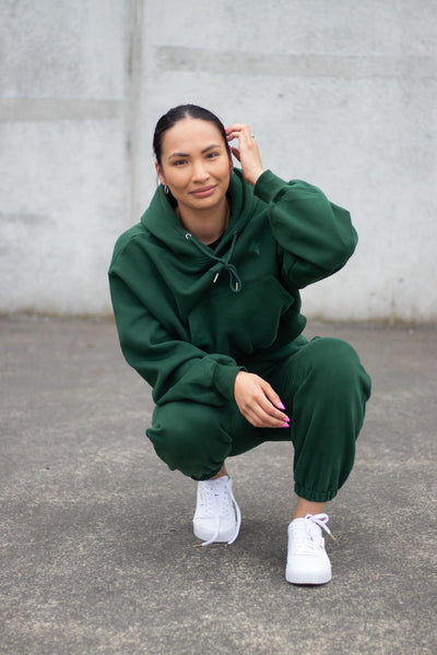 woman wearing loungewear hoodie and joggers in forest