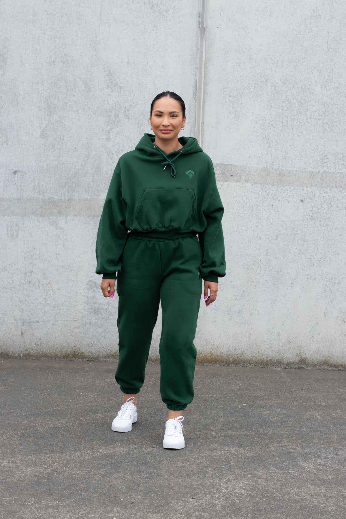 woman wearing loungewear hoodie and joggers in forest