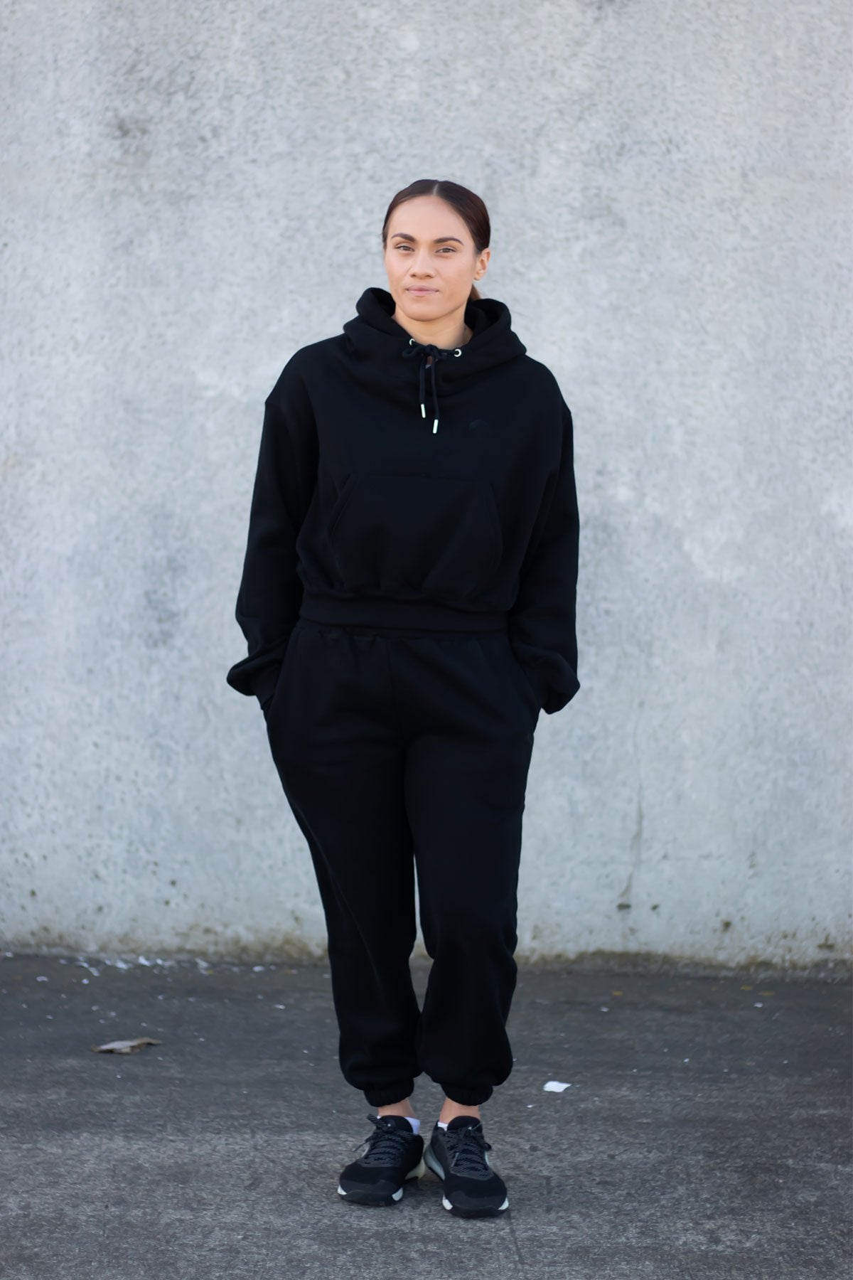 woman wearing loungewear joggers and hoodie in midnight black