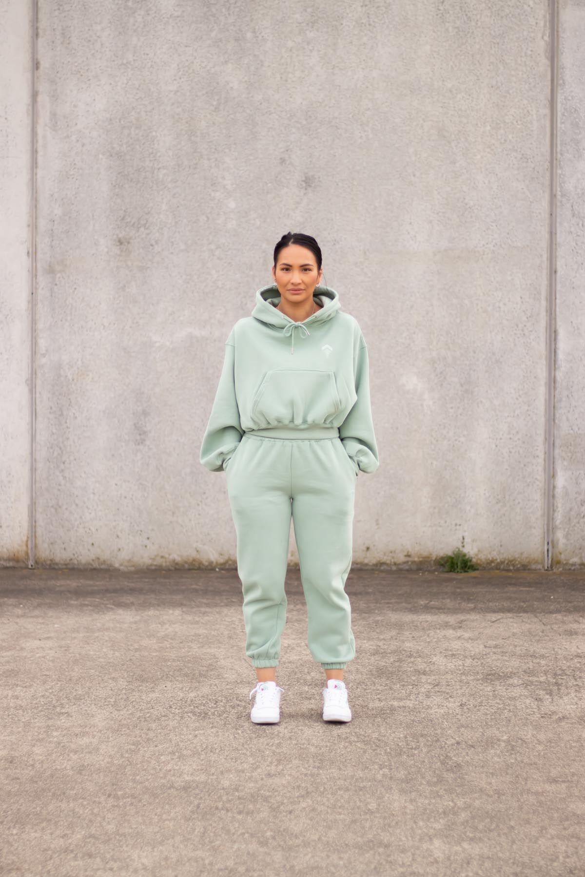 woman wearing loungewear joggers and hoodie in mint
