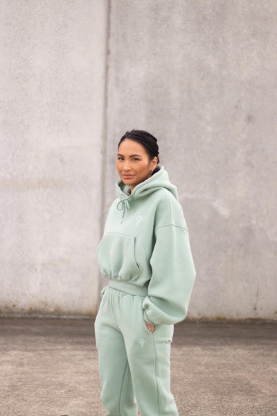 woman wearing loungewear hoodie and joggers in mint